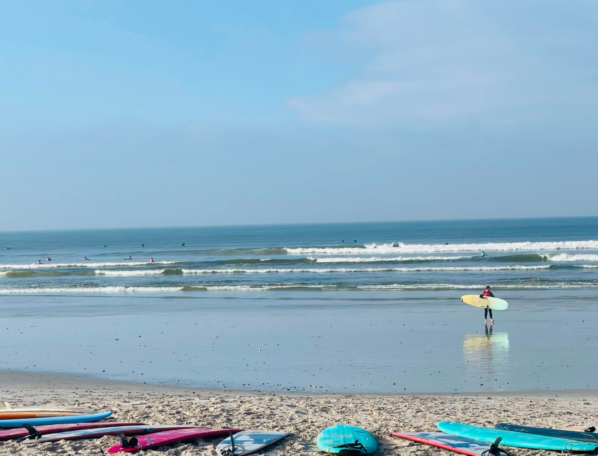 Surfboards lined up on the sand at Strand
